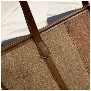 Detailed close-up of the vintage patchwork tote bag showing canvas texture and leather stitching