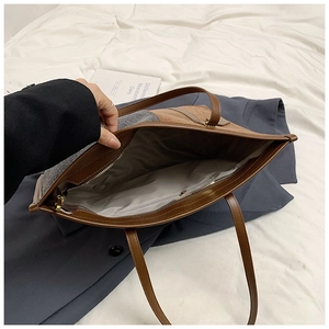 Detailed top view of contrast tote bag interior with grey lining and zipper pocket