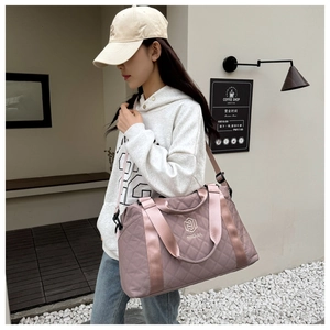 Close-up of pink quilted large capacity oxford travel bag with adjustable strap