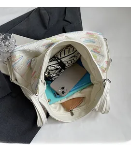Spacious interior of white tote bag showing storage for tablet, phone, and umbrella