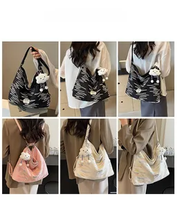 Detail of large tote bag showing colorful wave embroidery and white cloud charm