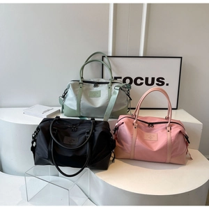 Waterproof nylon travel duffel bags in mint green black and pink colors on display