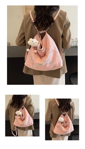 Pink quilted tote bag detail with plush cloud charm and embroidered wave patterns