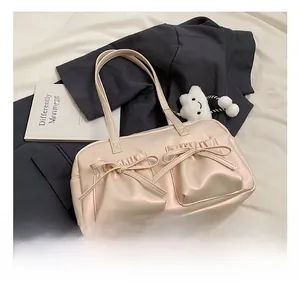 Detail of pink tote bag showing gathered pockets, bow accents and plush cloud charm
