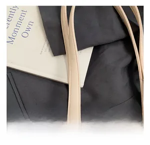 Detail of light beige bowling bag showing fine faux leather texture and neat stitching