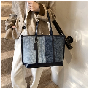 Detail of blue denim patchwork tote bag with high-capacity design for daily commute