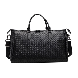 Large black woven leather duffel bag with handles and adjustable strap for travel