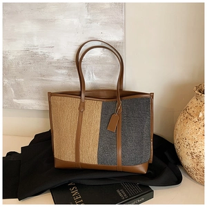 Detail of tweed tote bag with vertical khaki and dark grey patchwork and leather trim