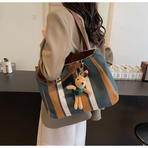 Green and brown striped canvas tote bag with a cute khaki rabbit plush pendant