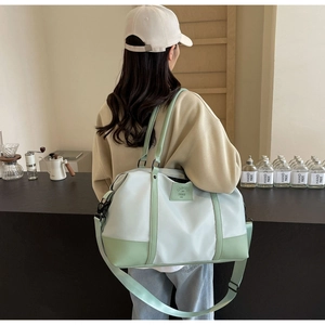 Detailed side view of large travel tote bag in green and white nylon fabric
