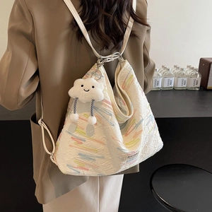 White embroidered tote bag with plush cloud charm, versatile shoulder and backpack design