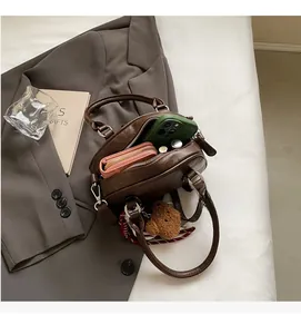 Detail view of brown vintage pillow bag showing spacious interior with phone and wallet