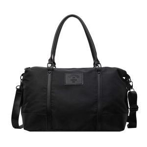 Large black travel duffel bag in waterproof nylon with leather accents and strap