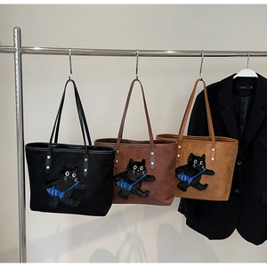 Detailed display of three tote bags featuring cute cartoon cat embroidery in various colors