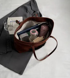 Interior view of brown tote bag showing spacious storage for tablet and umbrella