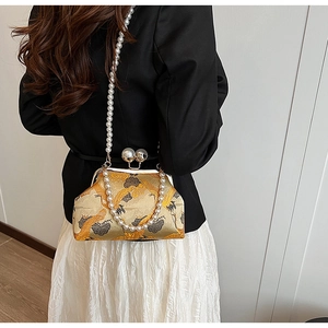 Detail of vintage Chinese gold brocade bag with crane embroidery and pearl straps