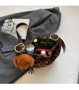 Spacious interior of leopard print crossbody bag showing large storage for phone and wallet