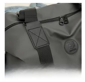 Detail of waterproof Oxford fabric travel bag with reinforced X-stitching and dual zippers