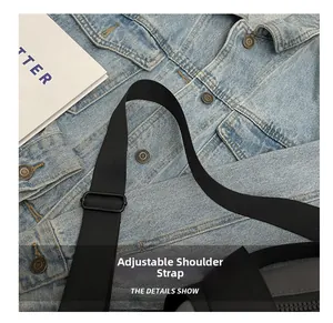 Detail view of the black adjustable nylon shoulder strap on a travel gym bag