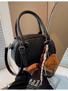 Retro black Boston handbag with plush bear charm and adjustable shoulder strap for women