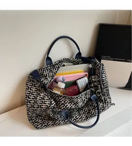 Large capacity tote bag showing spacious interior with laptop and travel essentials