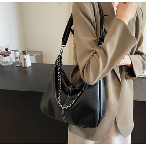 Detail der schwarzen Hobo-Tasche mit Kontrastnähten und silberner Metallketten-Deko
