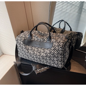 Close-up of a high-capacity woven travel bag with Hoco BAG leather brand patch details