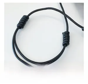 Detail of adjustable black round rope strap with minimalist knot on a leopard handbag