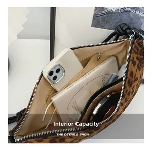 Detailed interior of leopard print crossbody bag showing pockets and daily essentials