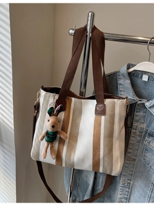 Fashionable canvas tote bag with brown stripes and a cute plush rabbit charm