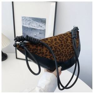Detail of leopard print patchwork crescent bag with black knotted rope shoulder strap