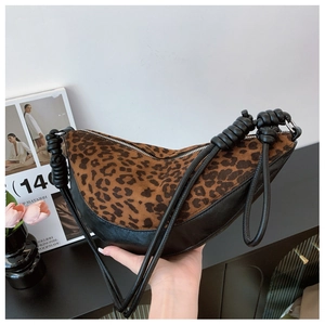 Detail of trendy dumpling bag featuring leopard print texture and knotted double rope straps