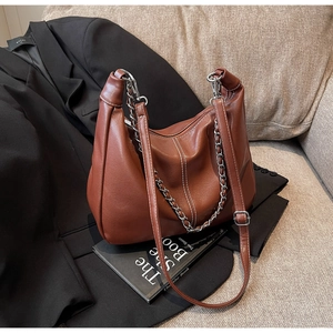 Detailansicht der braunen Hobo-Tasche mit Kontrastnähten und silberner Kette