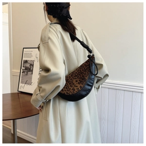 Close-up of leopard print dumpling bag with knotted shoulder strap detail
