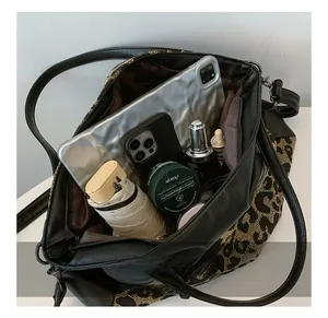 Interior view showing the large capacity of the leopard print tote with daily essentials