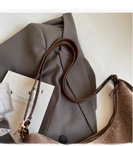 Detail of brown corduroy tote bag texture with premium leather strap and metal hardware