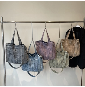 Detailed close-up of multiple vintage washed denim tote bags in diverse stylish colors