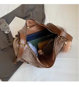 Detail of spacious brown corduroy tote interior with tablet, umbrella, and daily items