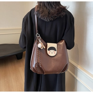 Detailed back view of a brown dumpling backpack featuring a baseball smiley face