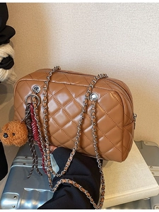 Brown quilted pillow shoulder bag with silver chain straps and a small bear charm