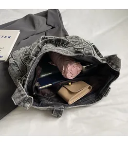 Interior view of large capacity washed denim tote bag showing pockets and storage space