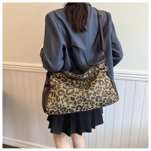 Detail of leopard print tote bag featuring premium canvas texture and leather strap