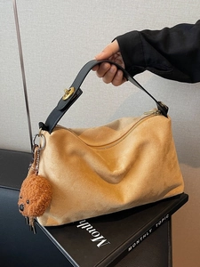 Brown suede tote bag with black handles and golden lock plus a cute puppy charm