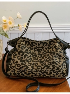 Chic leopard print tote bag with black leather trim and adjustable shoulder strap
