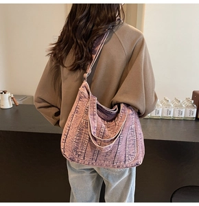 Close-up of purple denim tote bag with vertical stitching shown from a back view