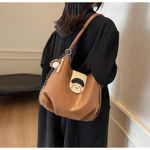Brown faux leather shoulder bag featuring a baseball smiley face print and cute charms