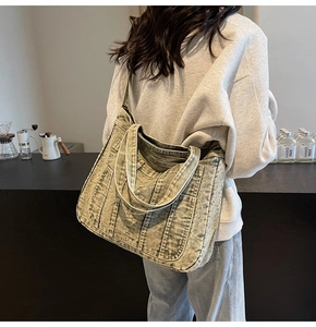 Casual vintage washed denim tote bag with multi-pockets shown in a cafe setting