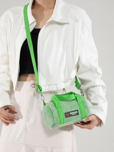 Chic mint green corduroy cylinder shoulder bag with contrasting lime green strap details