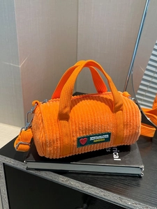 Orange corduroy cylinder handbag with crossbody strap and double handles for women