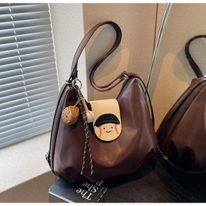 Detailed view of dark brown faux leather tote with baseball themed cartoon embroidery